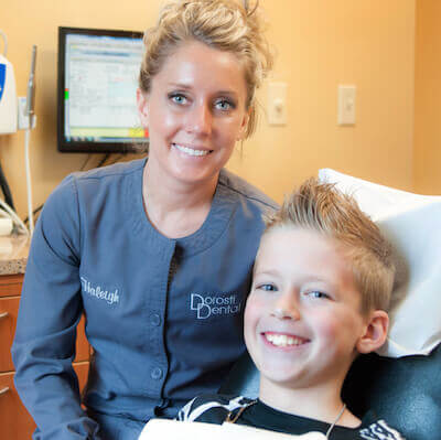 Hygienist and young boy patient