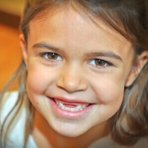 young girl missing front baby teeth