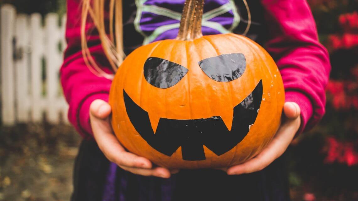 Girl holding pumpkin