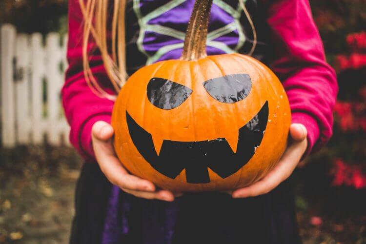 Girl holding pumpkin