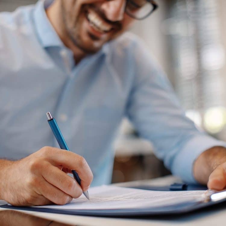 Man Writing on Paper